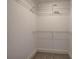 Empty walk-in closet featuring white walls, white shelving, and carpeted floors at 96 Rome St, Temple, GA 30179