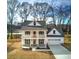 Two-story farmhouse with front porch, attached garage, and landscaped yard at 96 Rome St, Temple, GA 30179