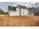 Exterior shot of the two-story new construction home with white siding and a sprawling backyard at 96 Rome St, Temple, GA 30179
