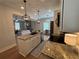 Open kitchen featuring granite counters, stainless appliances, and views into the spacious living area at 96 Rome St, Temple, GA 30179