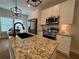 Granite countertops, stainless steel appliances, and a modern faucet highlight the stylish kitchen at 96 Rome St, Temple, GA 30179