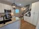 Bright kitchen with stainless steel appliances, granite countertops, and white cabinetry at 96 Rome St, Temple, GA 30179