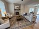 Bright living room features a brick fireplace, hardwood floors, and cozy seating at 96 Rome St, Temple, GA 30179