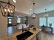 Open concept kitchen and living room featuring stylish lighting and hardwood floors at 96 Rome St, Temple, GA 30179