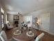 Open-concept space with a dining table and chairs in view of the living room and fireplace at 96 Rome St, Temple, GA 30179