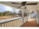Covered porch featuring wood flooring overlooking a wooded lot and a paved street at 96 Rome St, Temple, GA 30179