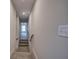 A bright stairwell features carpeted stairs and neutral walls, creating a welcoming transition between floors at 96 Rome St, Temple, GA 30179