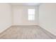 Simple bedroom with carpet, window, and door at 2429 Sardis Chase Ct, Buford, GA 30519