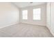 Well-lit bedroom with two windows and carpet at 2429 Sardis Chase Ct, Buford, GA 30519