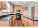 Modern kitchen with wood cabinets, granite counters, and island at 2429 Sardis Chase Ct, Buford, GA 30519