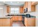 Modern kitchen with wood cabinets and granite countertops at 2429 Sardis Chase Ct, Buford, GA 30519