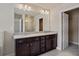 Double vanity bathroom with granite countertop and large mirror at 3807 Lockaby Way, Lawrenceville, GA 30044