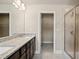 Double vanity bathroom with granite countertop and walk-in shower at 3807 Lockaby Way, Lawrenceville, GA 30044