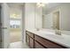 Bathroom with double vanity, large mirror, and access to bedroom at 420 Silver Brook Dr, Woodstock, GA 30188