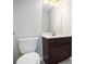 Clean bathroom with dark brown vanity, white toilet and a large mirror at 420 Silver Brook Dr, Woodstock, GA 30188