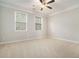 Well-lit bedroom featuring two windows and neutral wall tones at 420 Silver Brook Dr, Woodstock, GA 30188