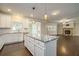 Open concept kitchen with white cabinets and granite island at 420 Silver Brook Dr, Woodstock, GA 30188