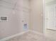 Convenient laundry room with shelving and tile flooring at 420 Silver Brook Dr, Woodstock, GA 30188