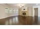 Spacious living room featuring hardwood floors, a stone fireplace, and abundant natural light at 420 Silver Brook Dr, Woodstock, GA 30188