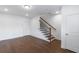 Finished basement with hardwood floors and staircase leading upstairs at 4223 Deming Cir, Atlanta, GA 30342