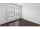 Bright bedroom with dark hardwood floors and a large window with blinds at 4223 Deming Cir, Atlanta, GA 30342