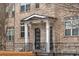 Townhome exterior featuring brick facade and a covered entryway at 4223 Deming Cir, Atlanta, GA 30342