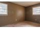 Simple bedroom with two windows and neutral walls at 785 Jett Rd, Jonesboro, GA 30236