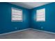 Blue bedroom with two windows and carpeting at 785 Jett Rd, Jonesboro, GA 30236