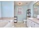 Bright bathroom with tiled floor, tub, shower and double vanity at 340 Annslee Cir, Loganville, GA 30052