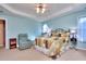 Bright bedroom featuring a ceiling fan and comfortable seating at 340 Annslee Cir, Loganville, GA 30052