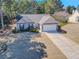 Beautiful single-Gathering home with a long driveway and lush front lawn on a sunny day at 340 Annslee Cir, Loganville, GA 30052