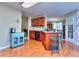 View of the kitchen with hardwood floors, cherry cabinets, and plenty of natural light at 340 Annslee Cir, Loganville, GA 30052