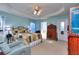 Spacious main bedroom with tray ceiling, fan, carpet, and natural light at 340 Annslee Cir, Loganville, GA 30052