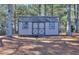 Tan colored storage shed with double doors at 340 Annslee Cir, Loganville, GA 30052