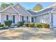 House exterior with American flag and manicured bushes at 340 Annslee Cir, Loganville, GA 30052