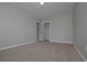 Simple bedroom with neutral walls and carpet, and a large closet at 5146 Manerdale Se Dr # 4, Atlanta, GA 30339