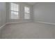 Bright bedroom with neutral carpeting and two windows at 5146 Manerdale Se Dr # 4, Atlanta, GA 30339