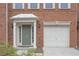 Green front door, white garage door, and brick facade at 5146 Manerdale Se Dr # 4, Atlanta, GA 30339