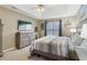 Main bedroom with a king-size bed and large dresser at 5220 Otter Creek Run, Cumming, GA 30040