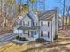 Two-story house with gray siding, gray roof, and a blue front door at 5220 Otter Creek Run, Cumming, GA 30040