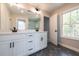 Bright bathroom with double sink vanity, black hardware, gray tile floor, and large window at 746 Trevett Way, Marietta, GA 30062