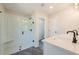 Bright bathroom featuring frameless glass shower, white vanity, and modern black hardware at 746 Trevett Way, Marietta, GA 30062