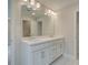 Double vanity bathroom with marble flooring and large mirror at 746 Trevett Way, Marietta, GA 30062