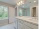 Double vanity bathroom with marble flooring and large mirror at 746 Trevett Way, Marietta, GA 30062