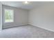 Simple bedroom with gray carpet and large window at 746 Trevett Way, Marietta, GA 30062