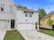 Two-story townhome with gray and white exterior, two-car garage, and landscaped lawn at 746 Trevett Way, Marietta, GA 30062