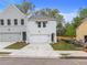 Two-story townhome with gray and white exterior, two-car garage, and landscaped lawn at 746 Trevett Way, Marietta, GA 30062