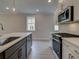 Modern kitchen with white cabinets, quartz countertops, and stainless steel appliances at 746 Trevett Way, Marietta, GA 30062