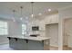 Modern kitchen with gray island, white cabinets, and stainless steel appliances at 746 Trevett Way, Marietta, GA 30062