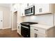 Sleek kitchen featuring black hardware, a gas range, and shaker-style cabinets at 746 Trevett Way, Marietta, GA 30062